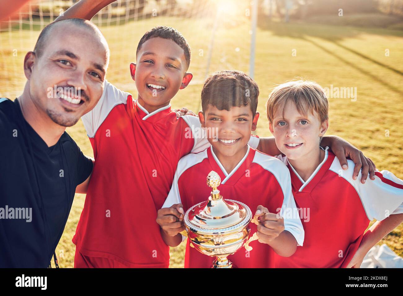 Soccer, football team and coach winning trophy from competition game with passion, motivation and teamwork. Sport collaboration achievement, group Stock Photo