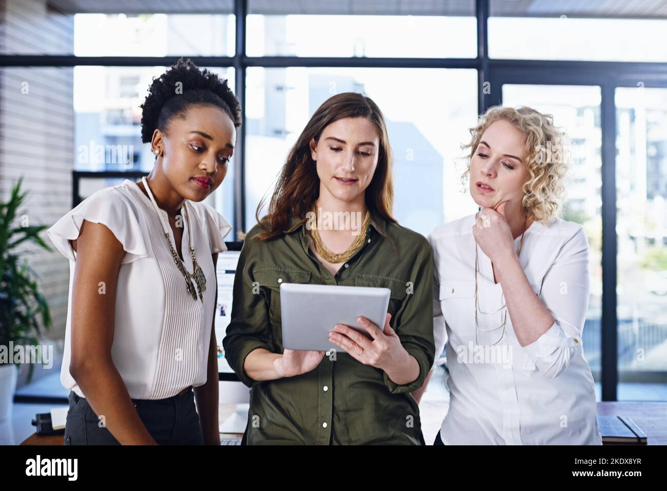 Considering all their options very carefully. a team of designers working together in the office. Stock Photo