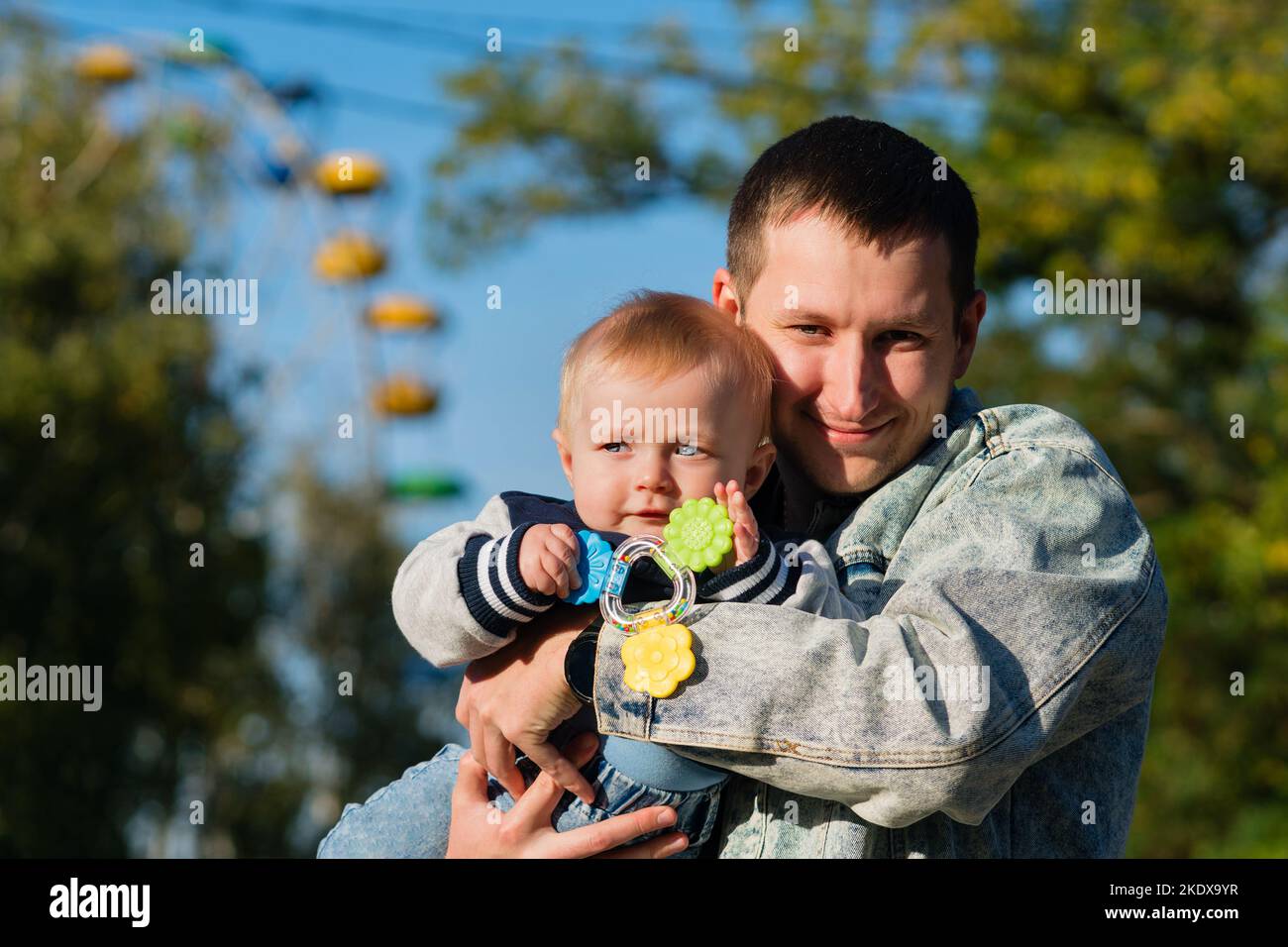Father holding baby son. Adorable child having fun with dad in park ...