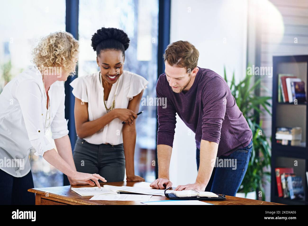 Ensuring that their plans are all clear and concise. a team of designers working together in the office. Stock Photo