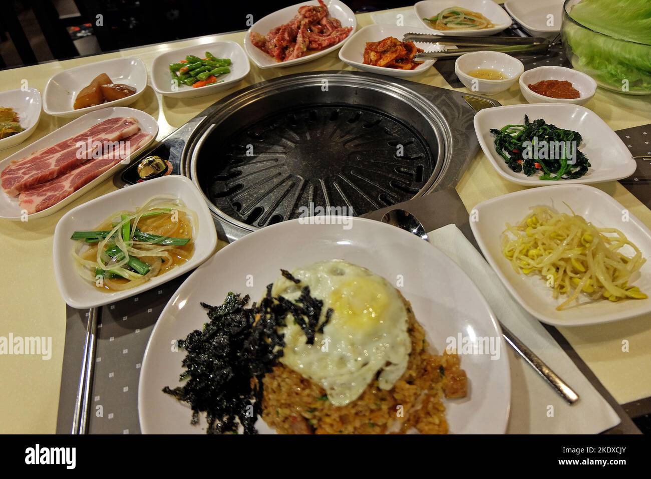 Korean pork barbecue served with assorted pickled vegetable side dishes