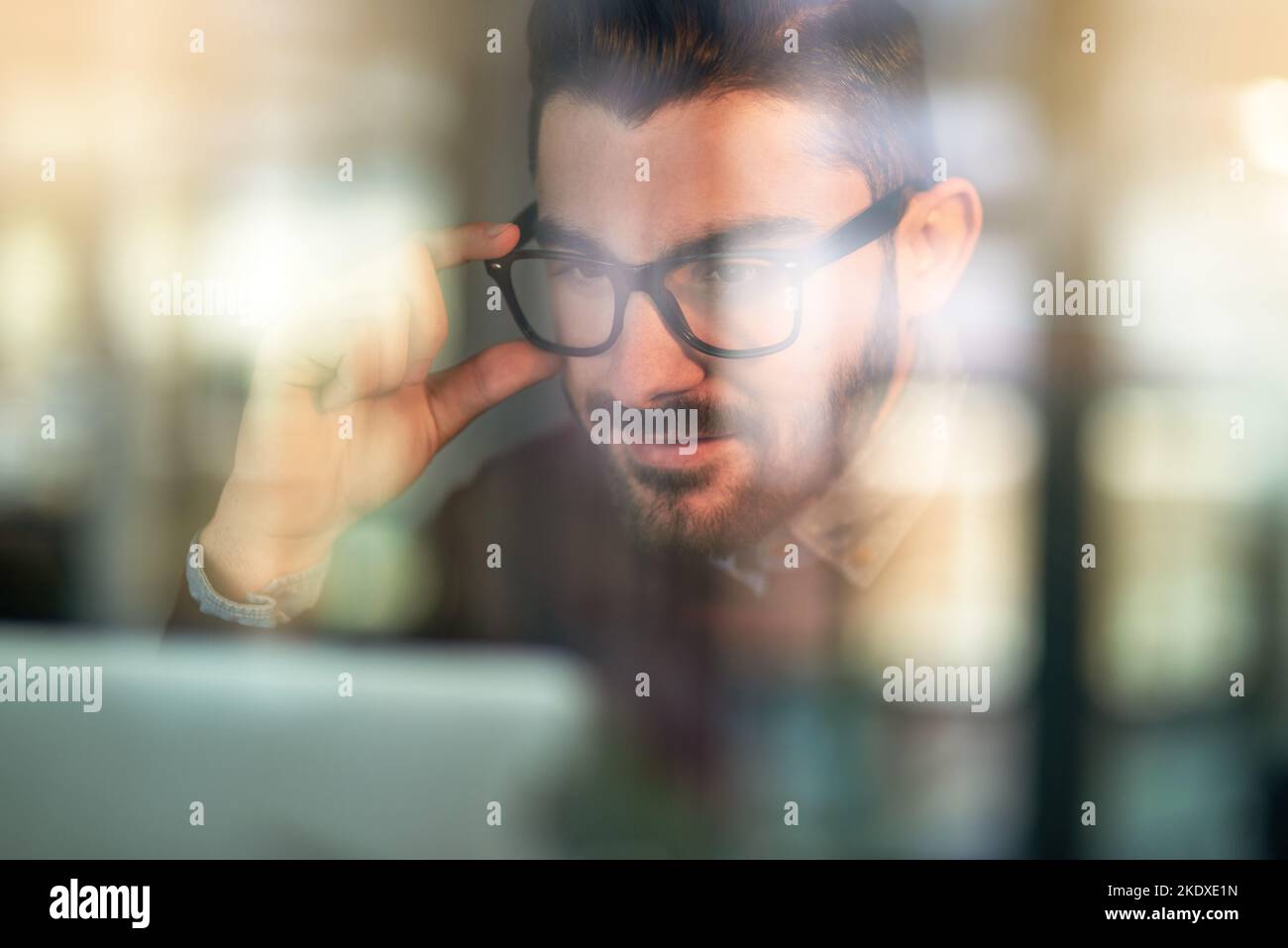Hes got this project in his sights. a focused young programmer working ...