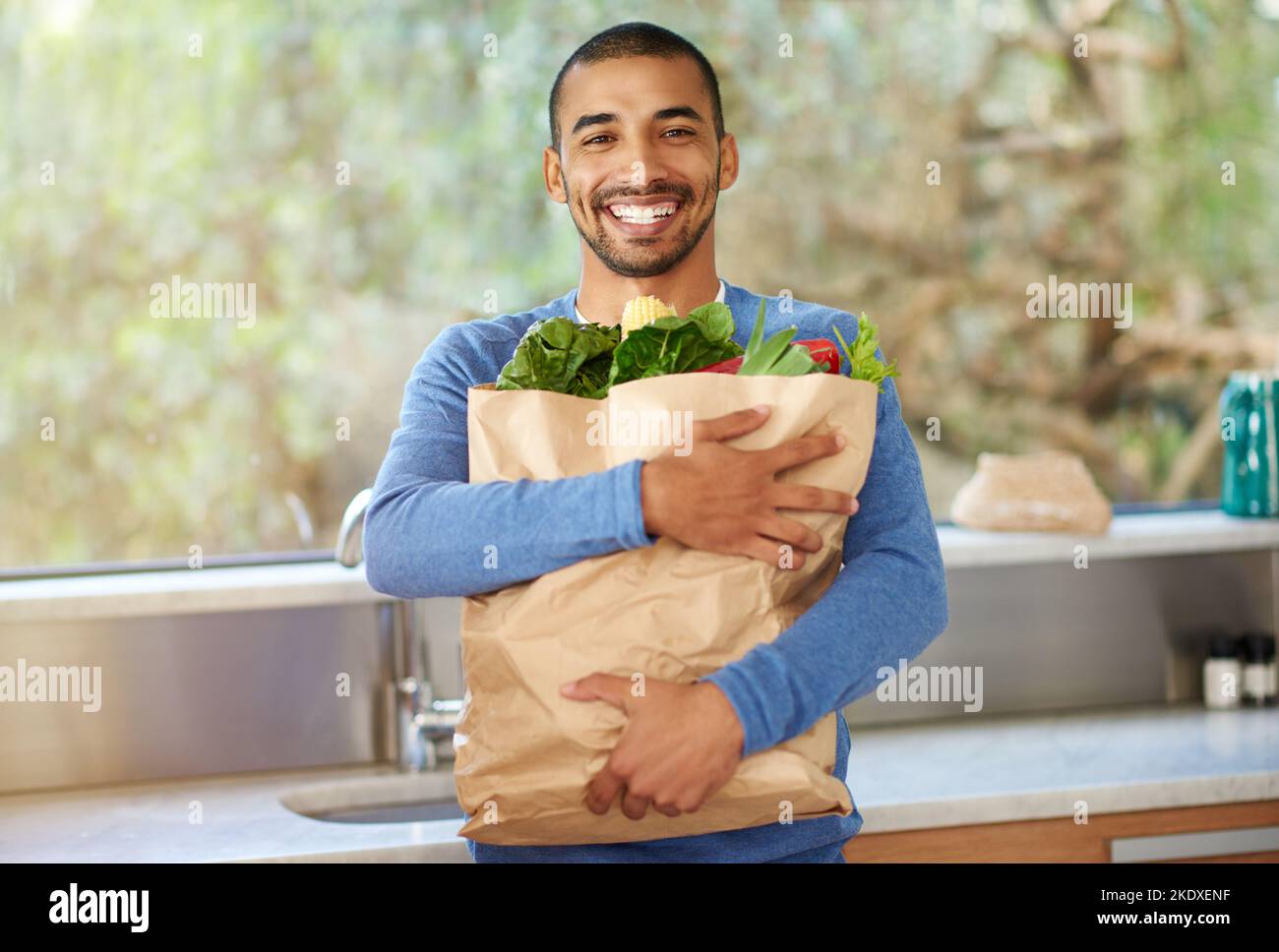 Starting my new organic diet. Cropped portrait of a handsome young man standing in the kitchen with his groceries. Stock Photo