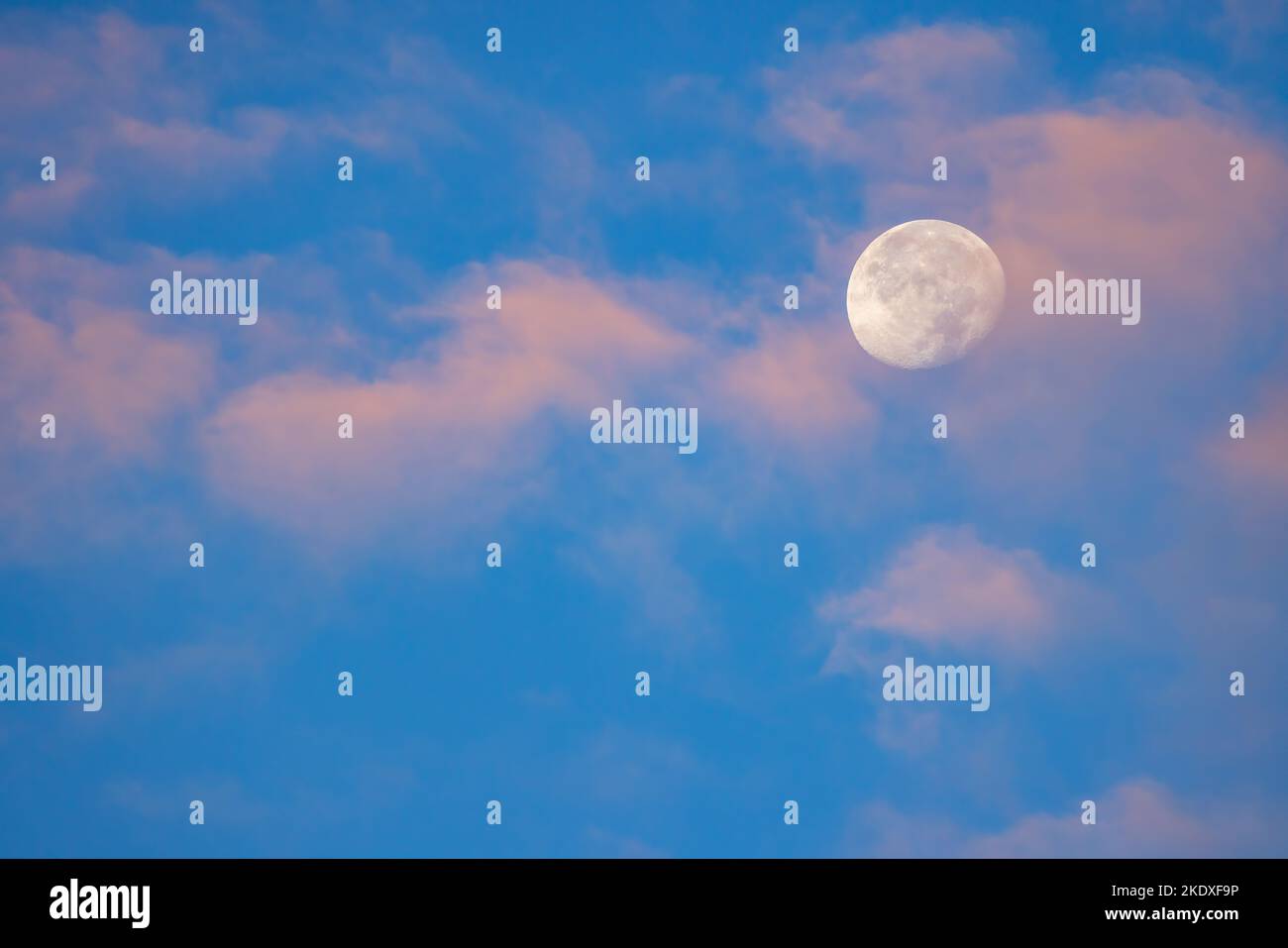 Blue sky with moon and clouds Stock Photo