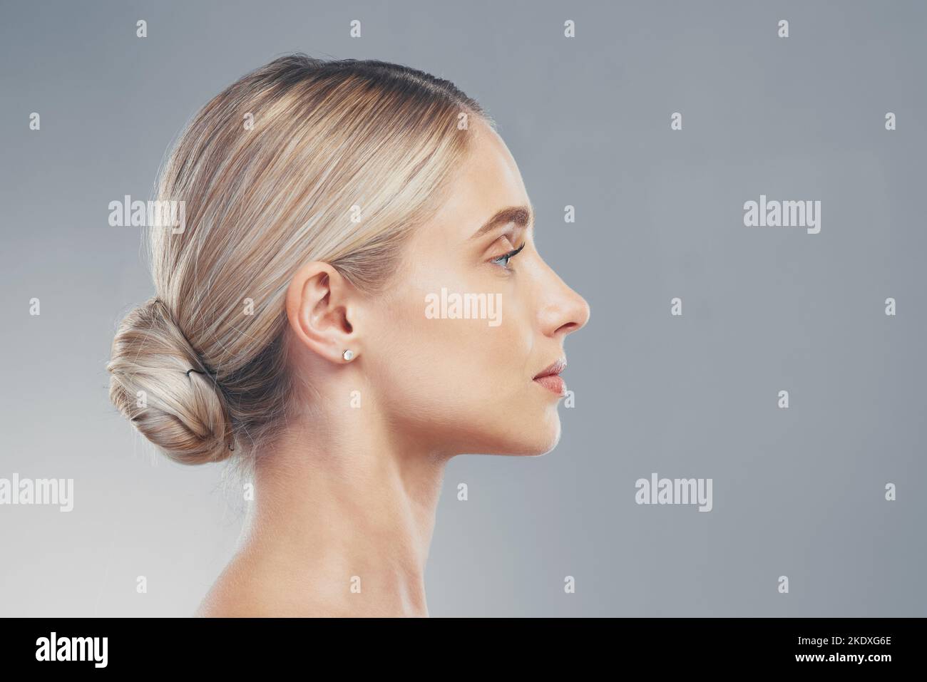 Skincare, profile and side face of a woman for dermatology, wellness and natural beauty against a grey mockup studio background. Advertising Stock Photo