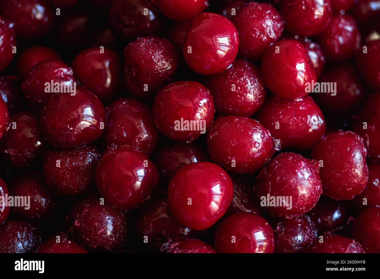 Frozen red cherry. Juicy ripe berry. View from top. Background full frame.. Stock Photo