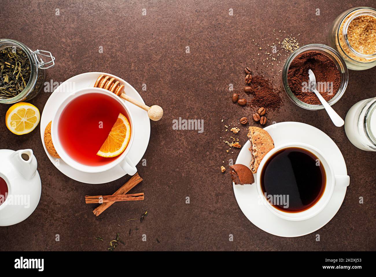 Cups of hot coffee and tea with ingredients on dark background Stock Photo