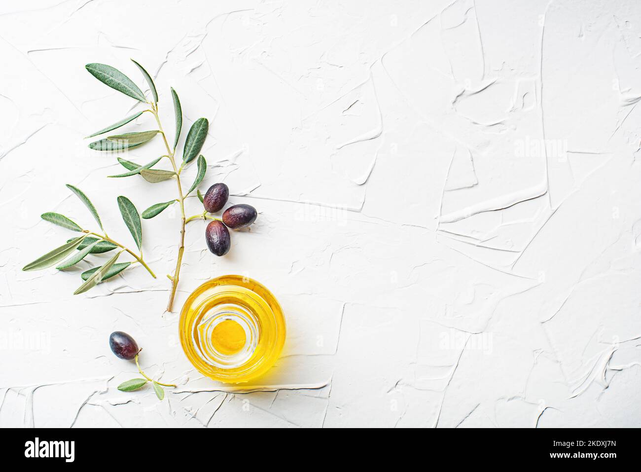 Olive oil bottle and olive branch on white background Stock Photo