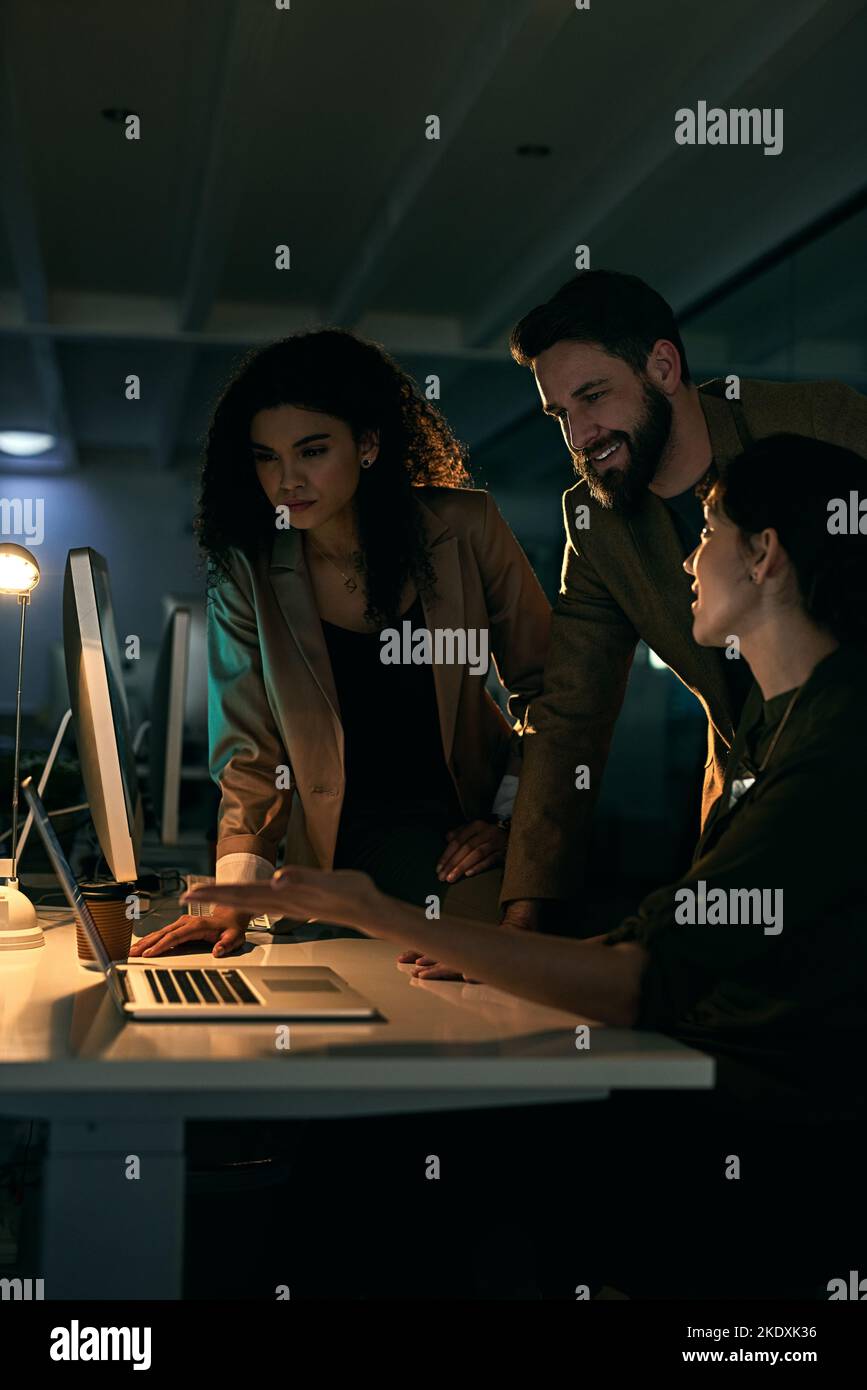 Nothing is impossible when it comes to this trio. colleagues working late. Stock Photo