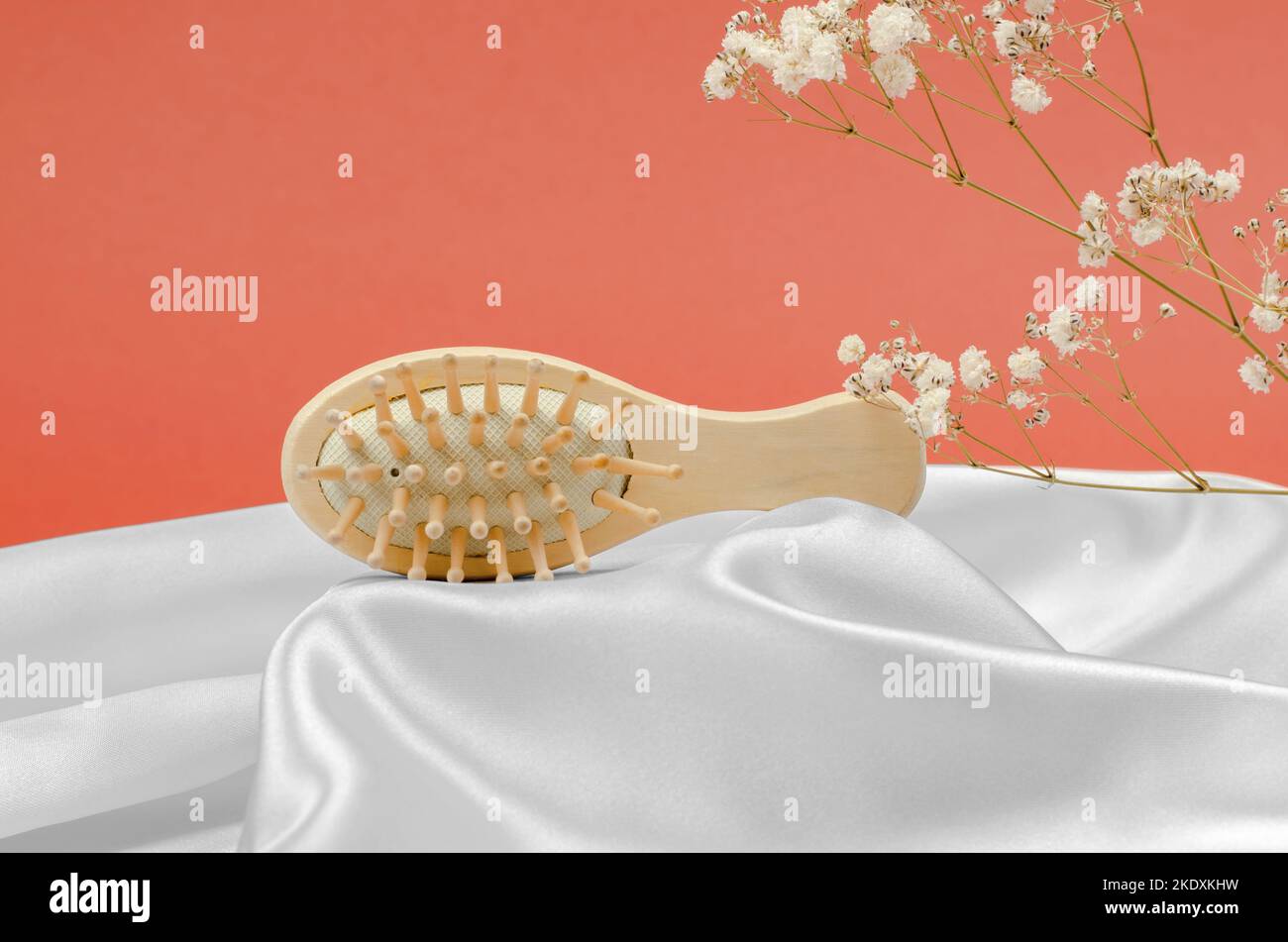Wooden hairbrush on a podium made of silk fabric Stock Photo Alamy