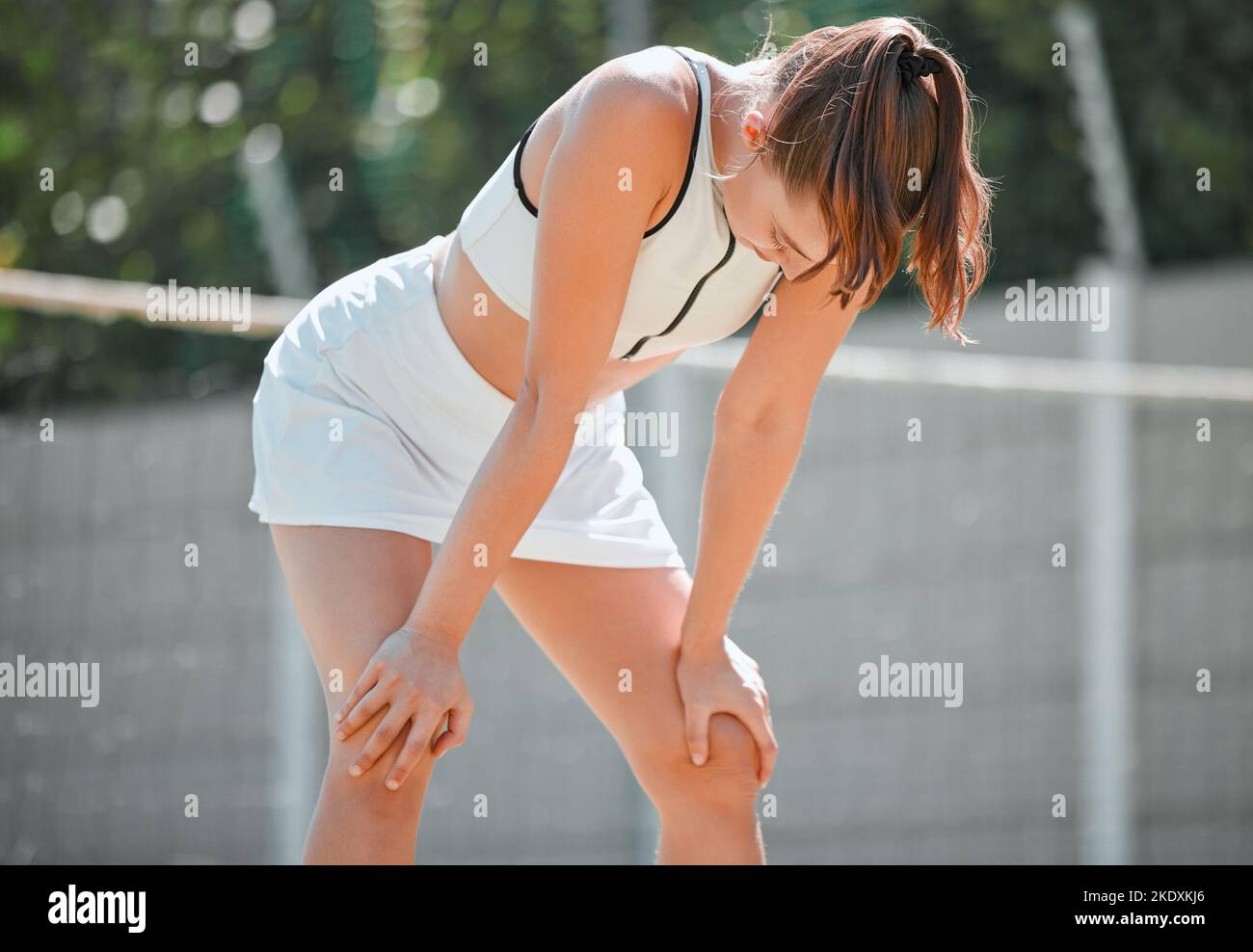 Young woman, athlete and tired on court, training and resting for competition, relax and breathing outdoor. Healthy female, girl and exhausted after Stock Photo