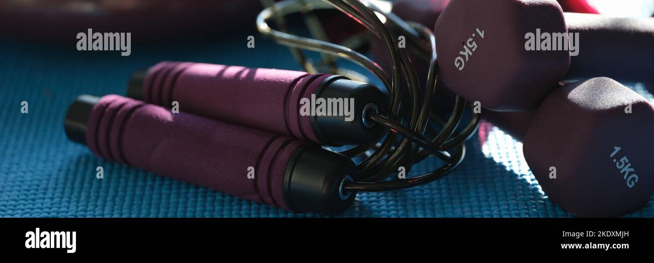 Jump rope and dumbbells, athletes set for workout Stock Photo Alamy