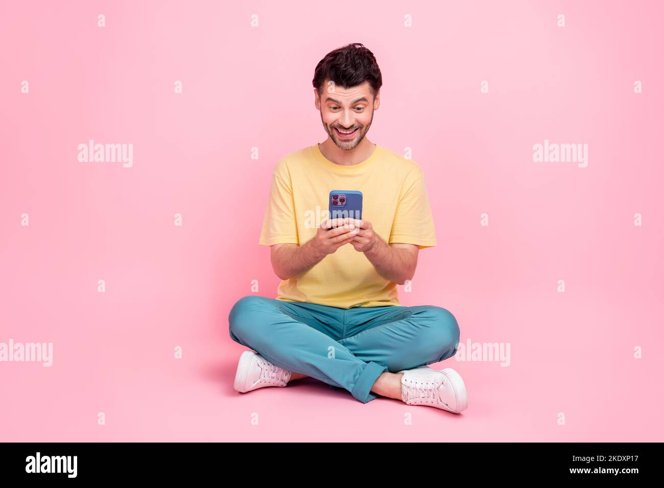 Photo of positive glad man hold iphone watching video chatting instagram  facebook twitter followers isolated on pink color background Stock Photo -  Alamy