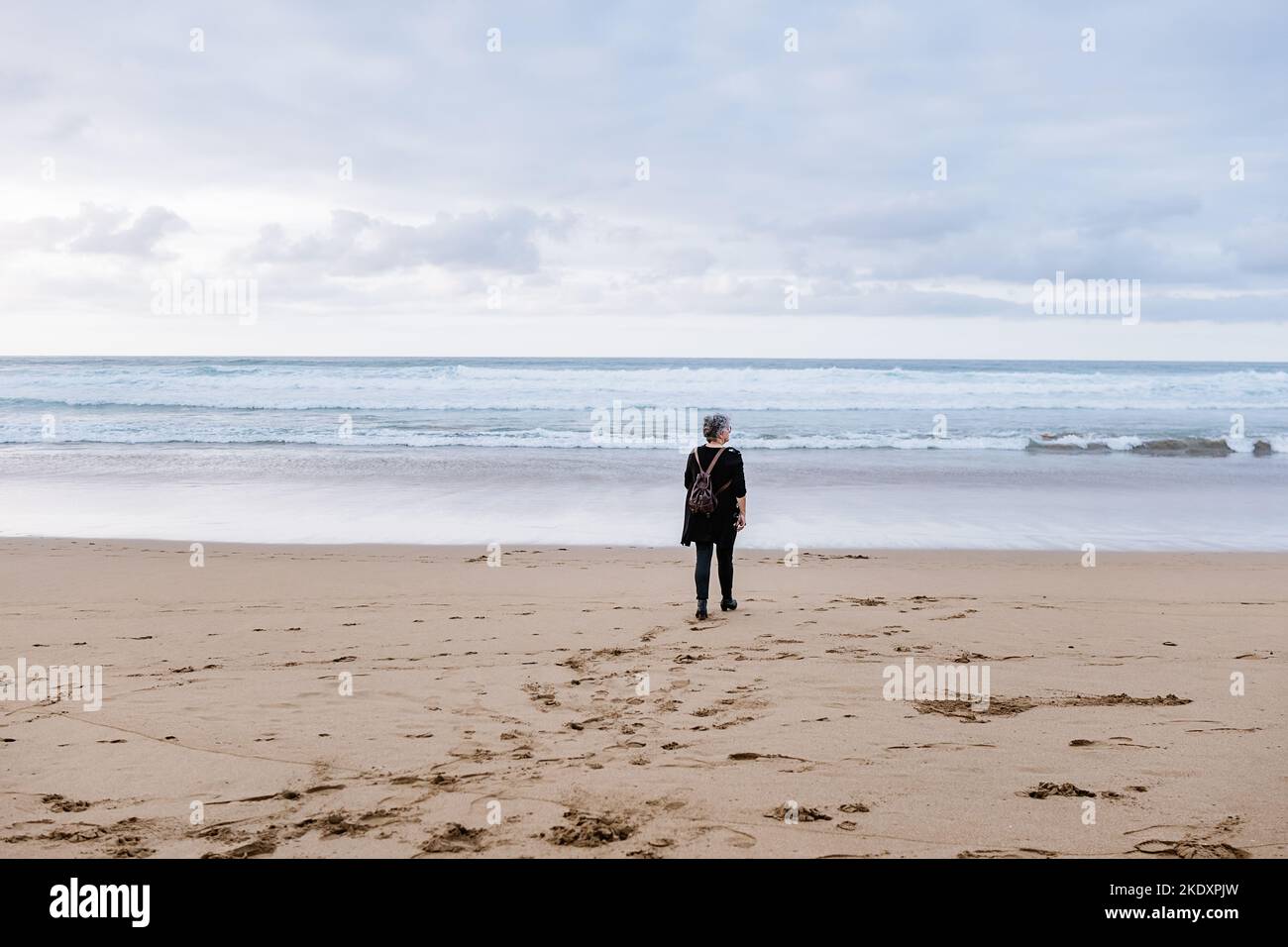 Woman on beach looking towards hi-res stock photography and images - Alamy