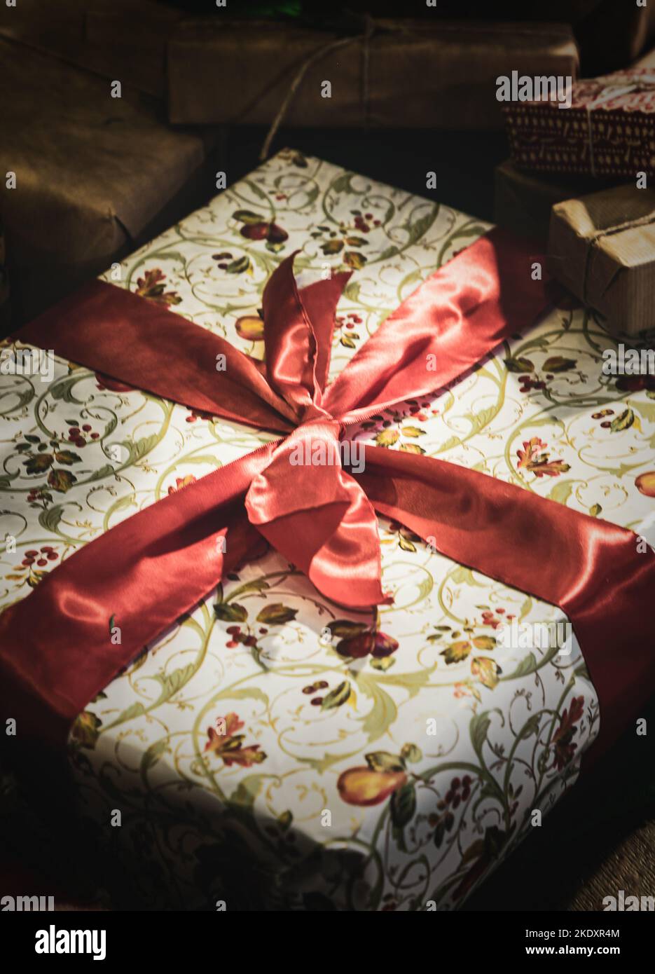 A pile of wrapped Christmas presents tied up in red ribbon Stock Photo ...