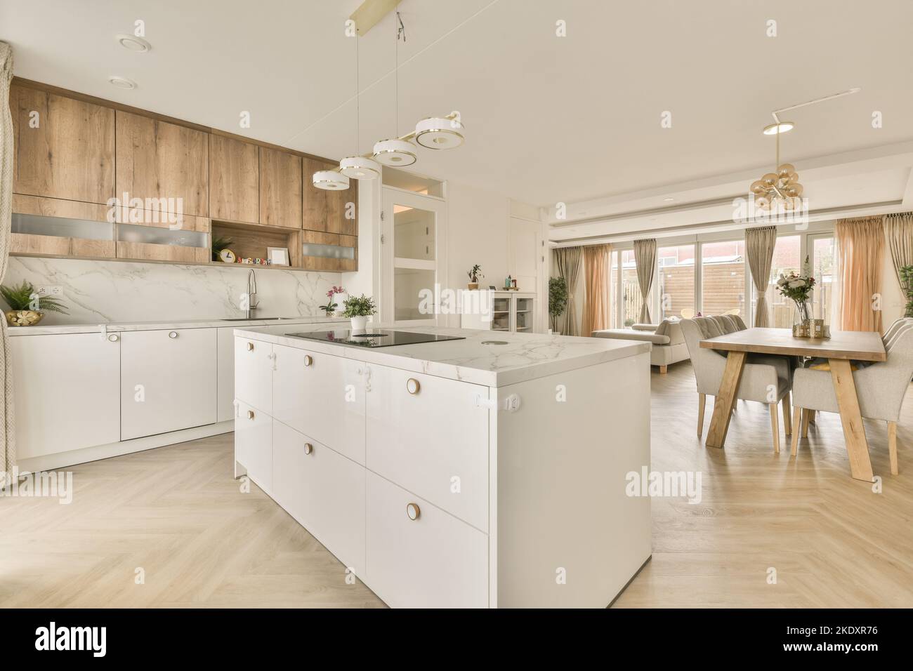Contemporary open plan kitchen near dining table and living room ...