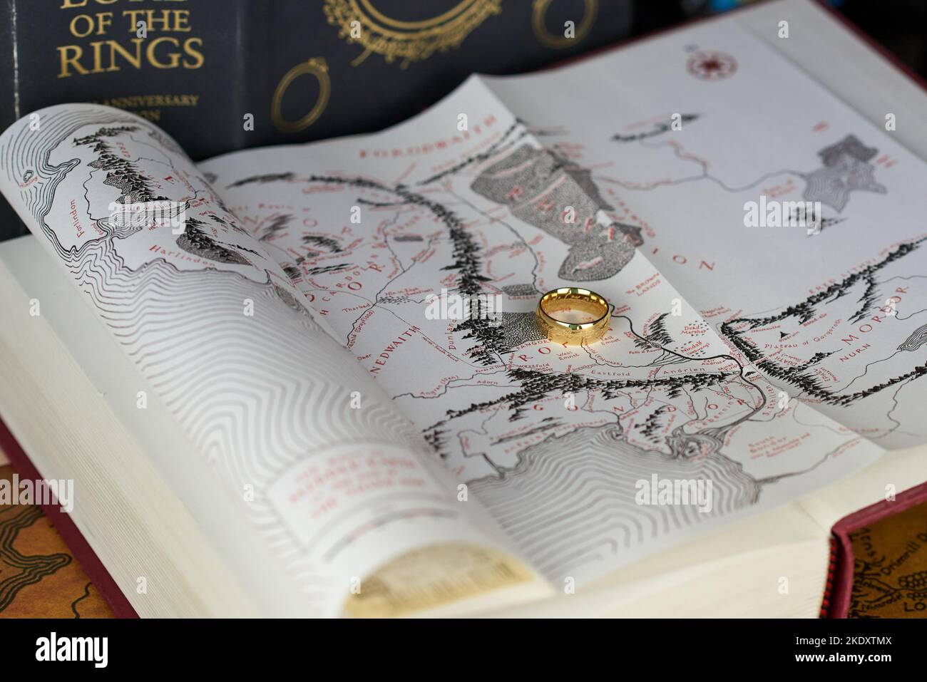 Astrakhan, Russia - 11.09.2022: Golden Ring of Power lies on the map in The Lord of the Rings book Stock Photo