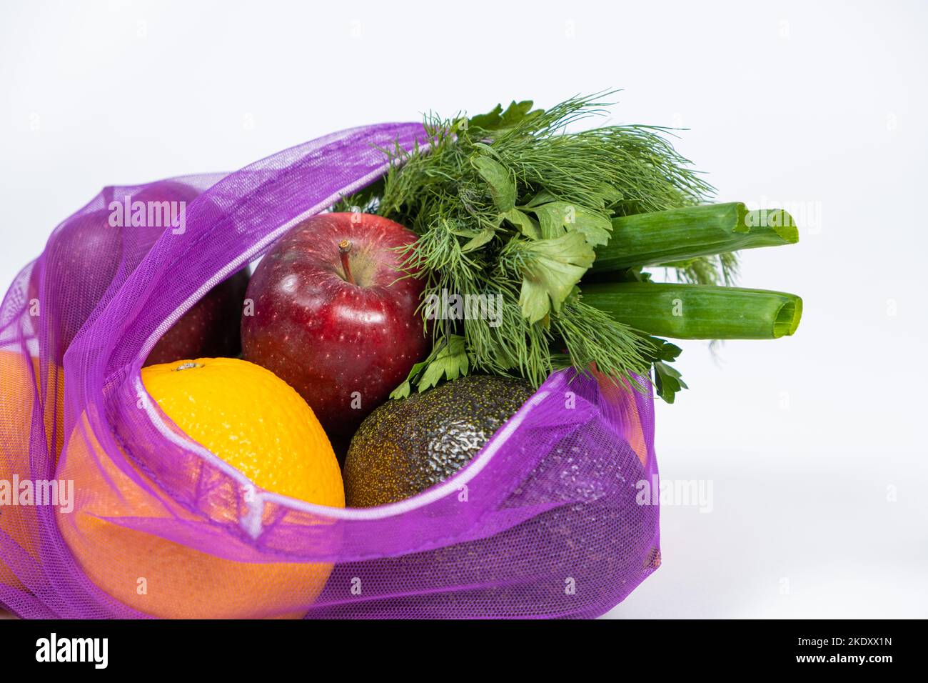 Fabric mesh for fruits and vegetables on a white background. A reusable