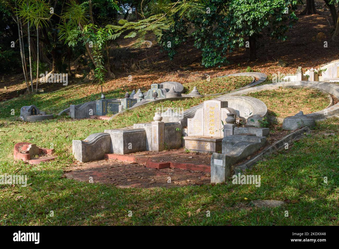 Malacca City, Malaysia - February 28th 2018: A traditional Chinese grave at Bukit China (Chinese Hill), a hillside cemetery with over 12,000 graves. Stock Photo