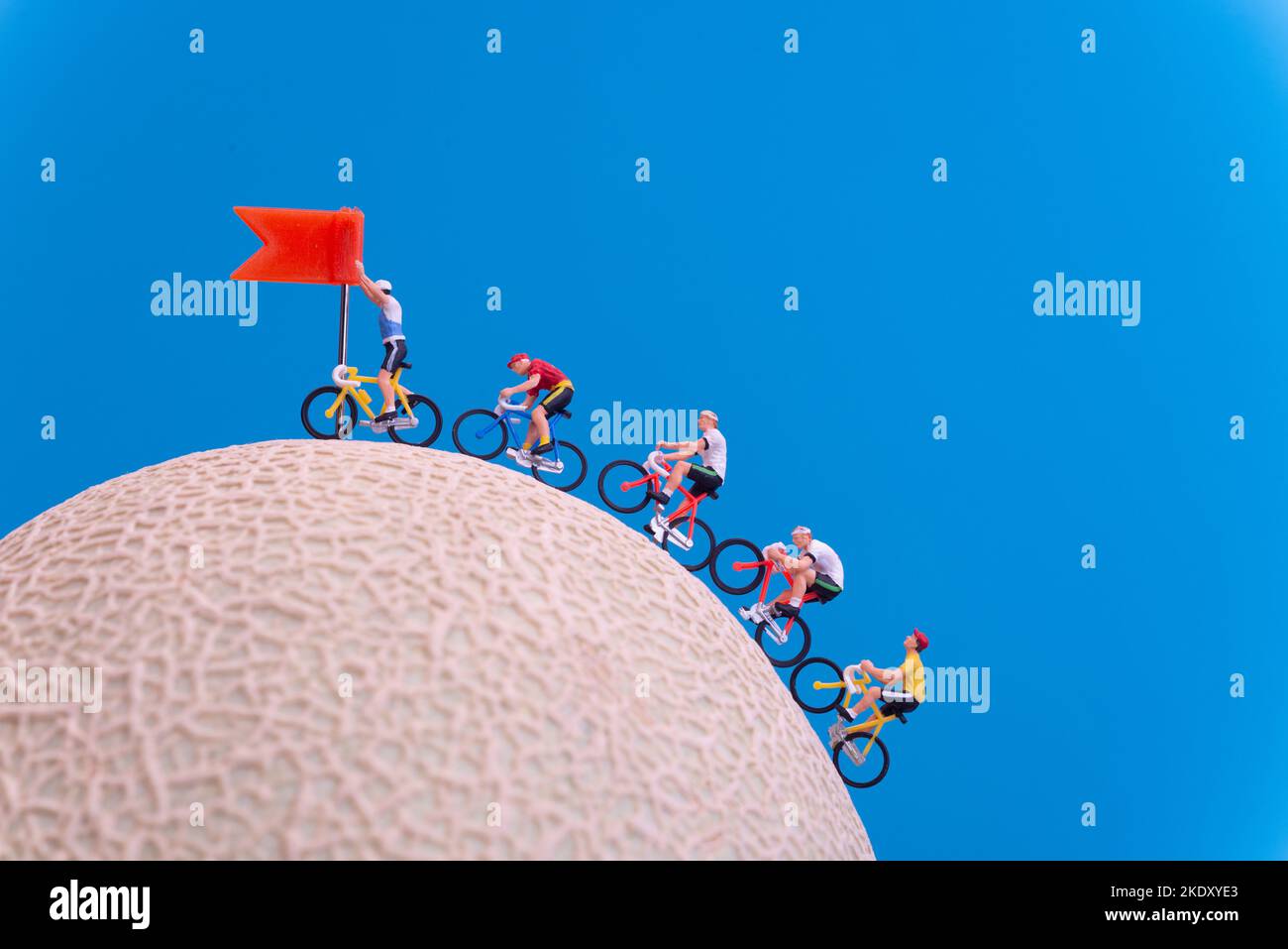 Miniature toys - road cyclist approaching finish line, celebration concept. Stock Photo