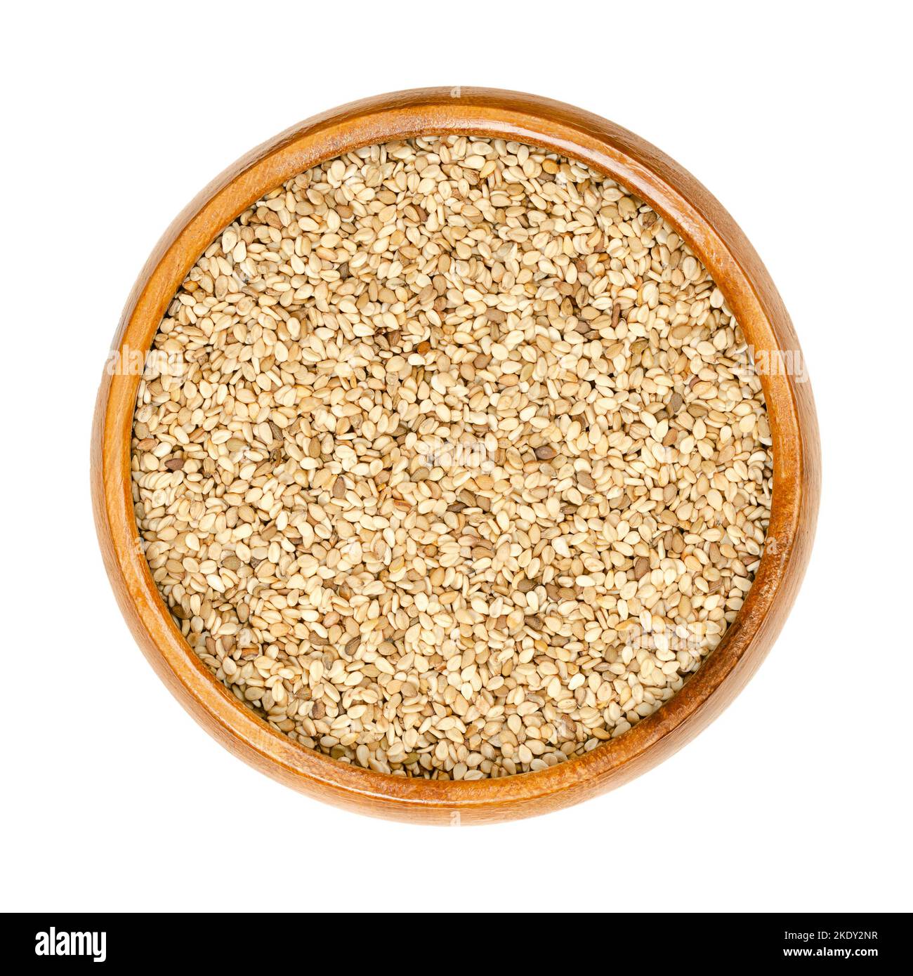 Unhulled sesame seeds, benne in a wooden bowl. Seeds of Sesamum indicum, with rich and nutty
