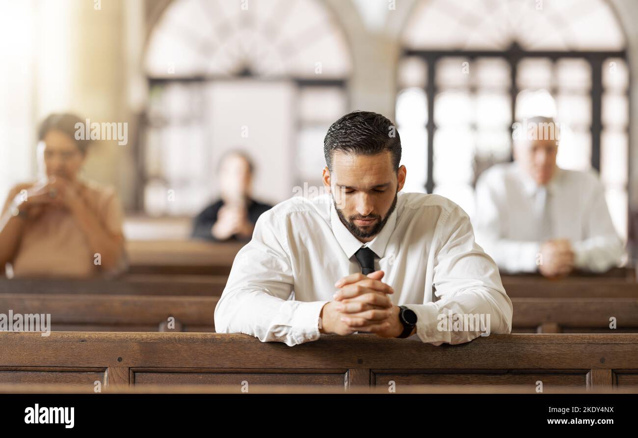 Church, prayer and man praying to God, worship or religion in cathedral. Faith, spiritual and christian community in chapel or sanctuary worshipping Stock Photo