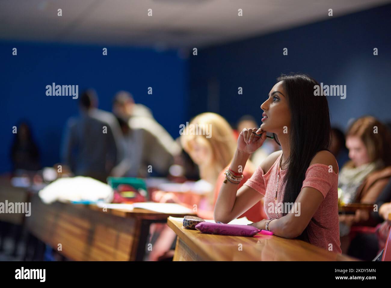 Completely focused on the lecture. a beautiful university student making notes while sitting in a lecture hall. Stock Photo