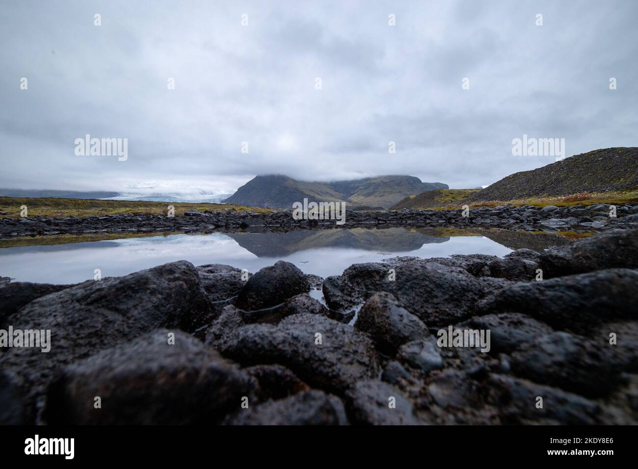 A landscape view of the rock's reflection on the lake Stock Photo - Alamy