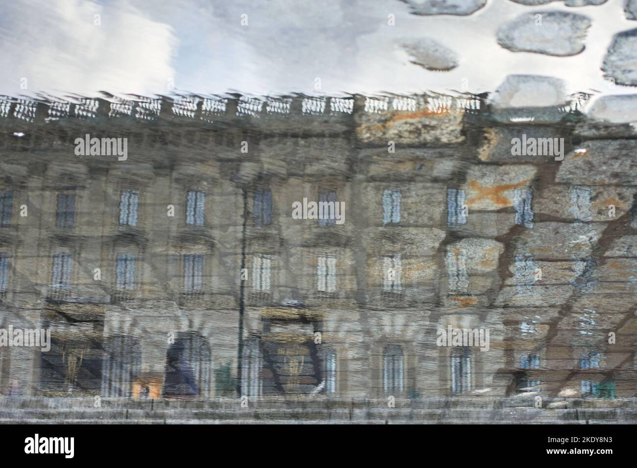 The Royal Palace of Stockholm in reflection from the cobble stone street puddle. Stock Photo