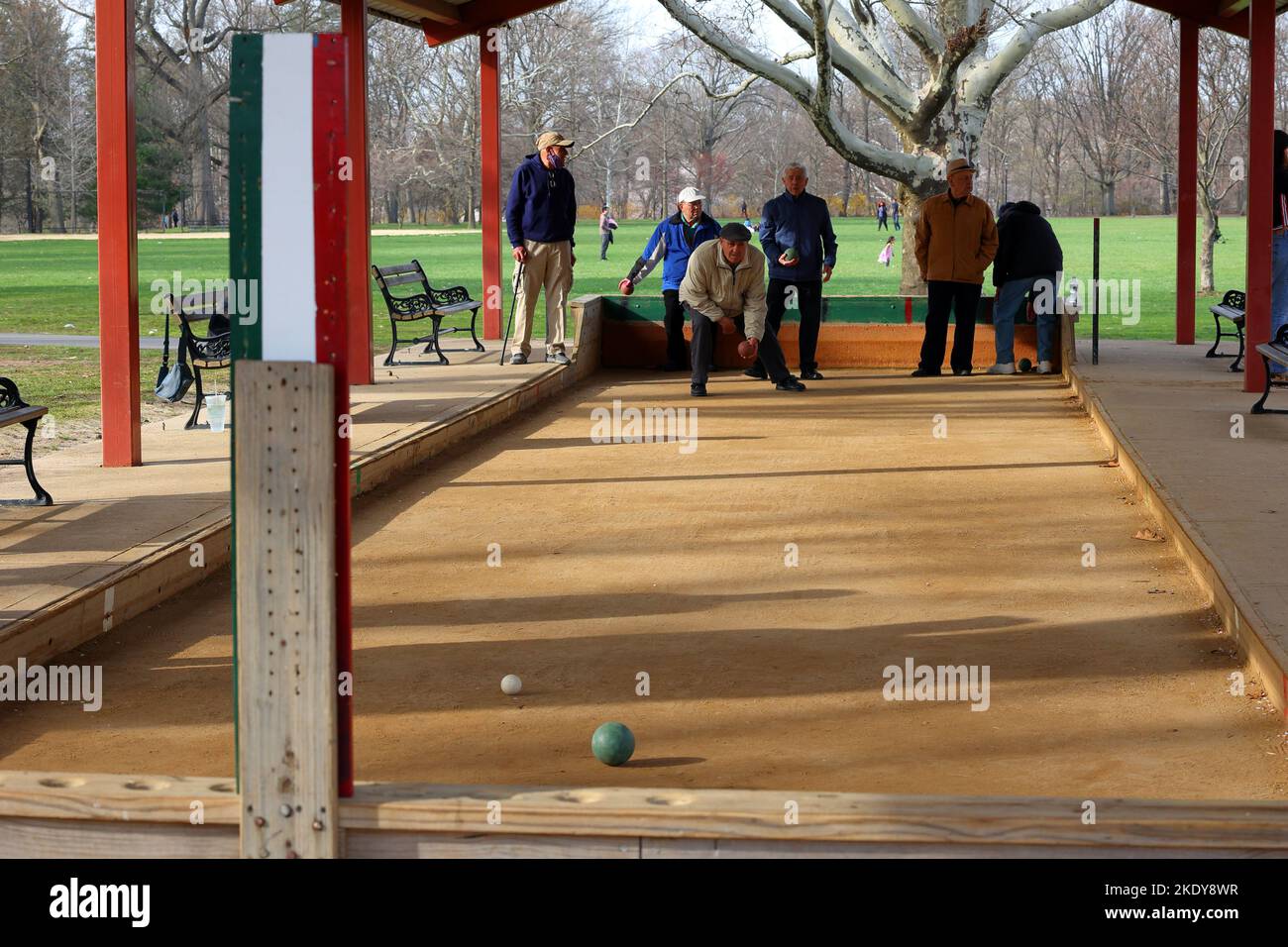 Italian-American seniors play bocce at a covered, outdoor bocce court at Cherry Blossom Welcome Center in Branch Brook Park, Belleville, New Jersey Stock Photo
