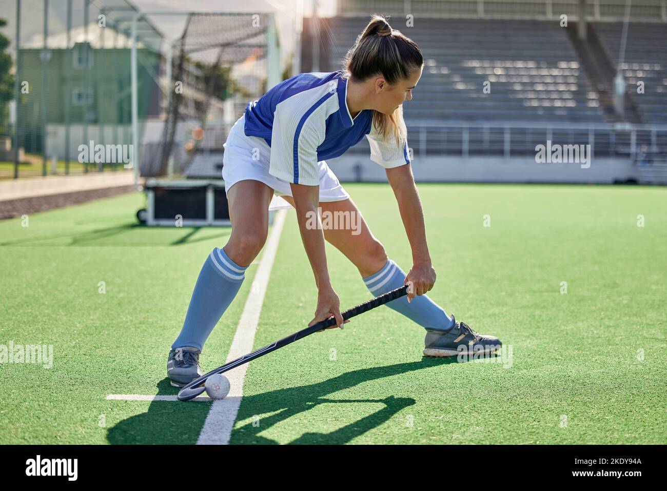 Sports, hockey and woman in action on field with hockey stick ready to