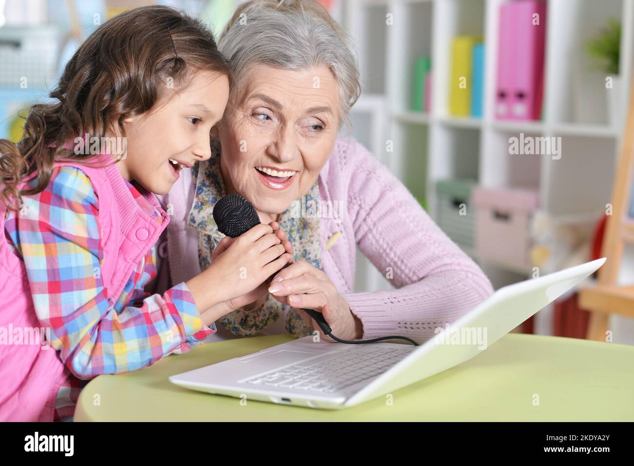 portrait of grandmother and daughter singing karaoke Stock Photo Alamy