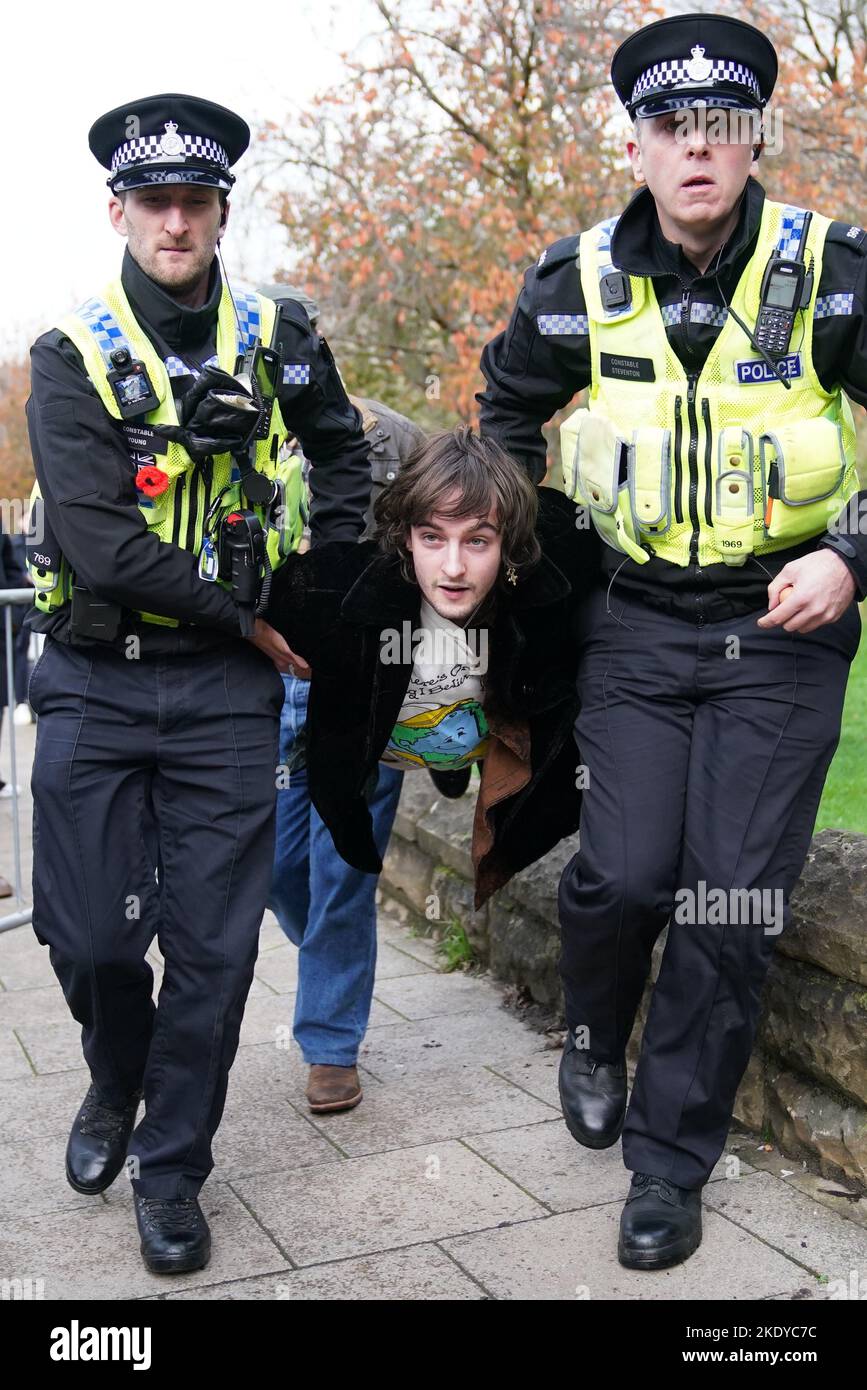 Police detain protester Patrick Thelwell after he appeared to throw ...