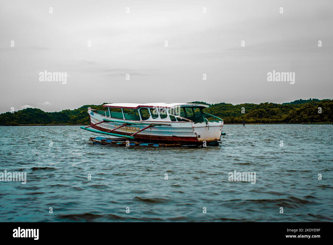 A long fishing boat sailing on the water near Zambales, Philippines Stock Photo