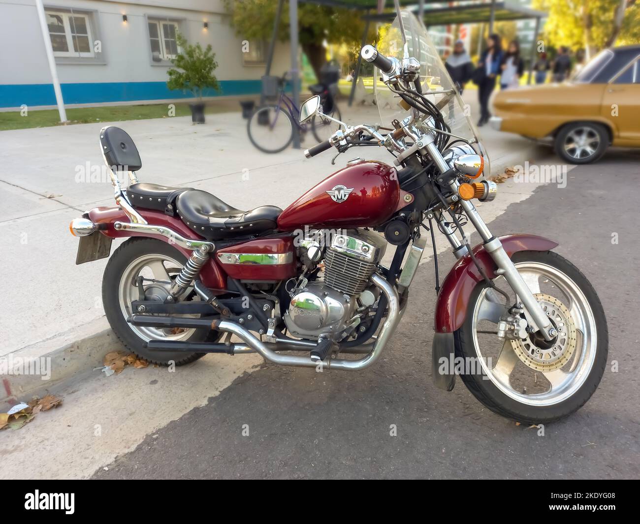 A red Mondial HD 250 A custom chopper motorcycle on the street at a car ...
