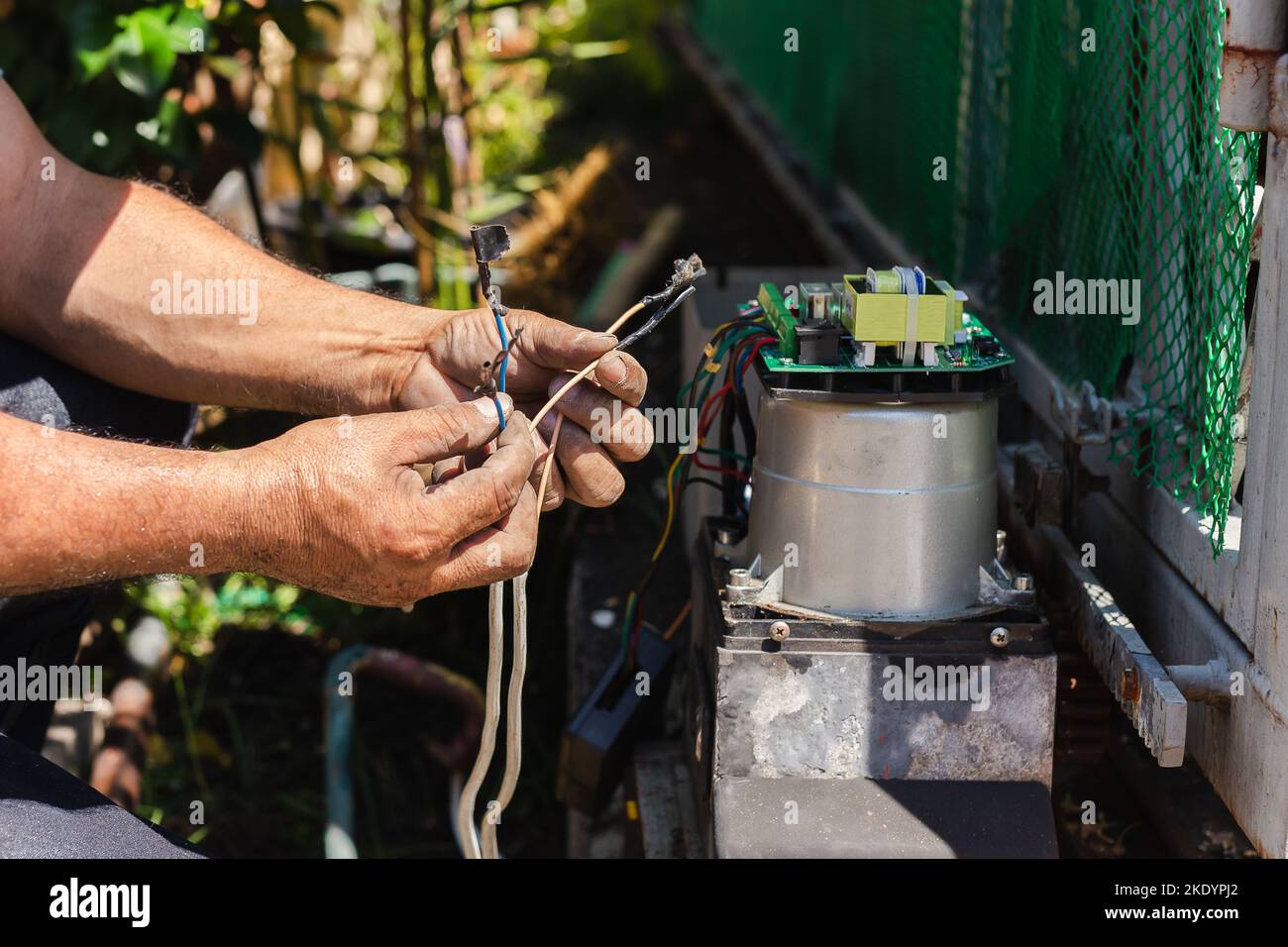 Technician man installing automatic electronic gate in the house Stock