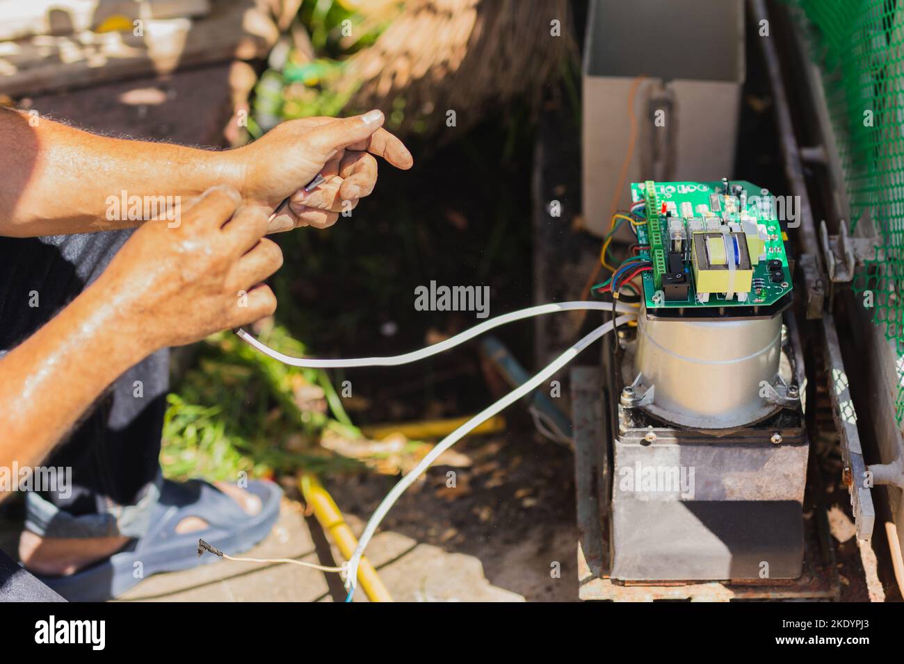 Technician man installing automatic electronic gate in the house Stock