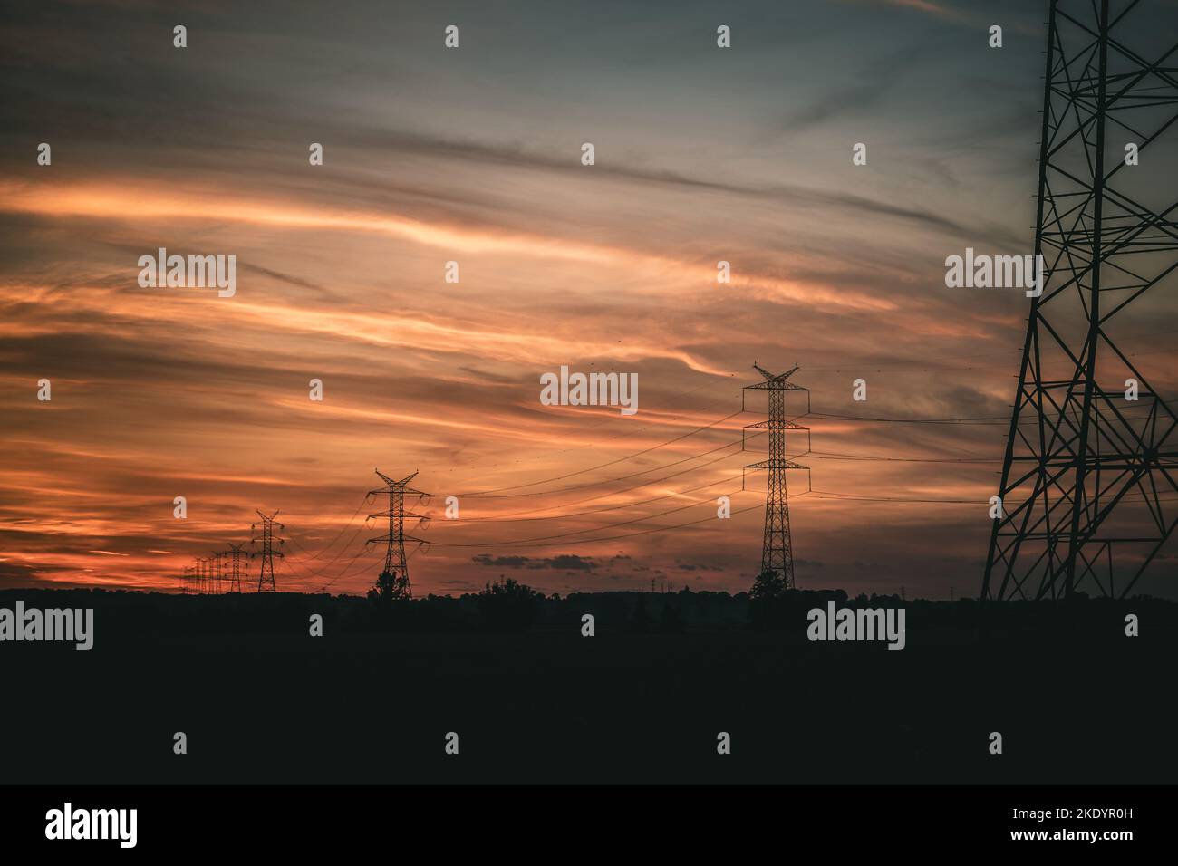 The silhouettes of transmission towers at sunset Stock Photo - Alamy