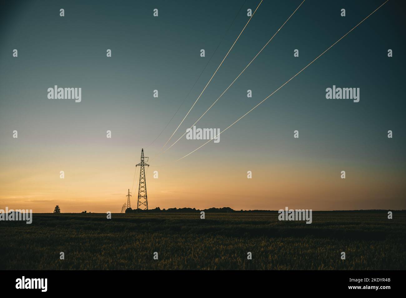 The silhouettes of transmission towers at sunset Stock Photo - Alamy