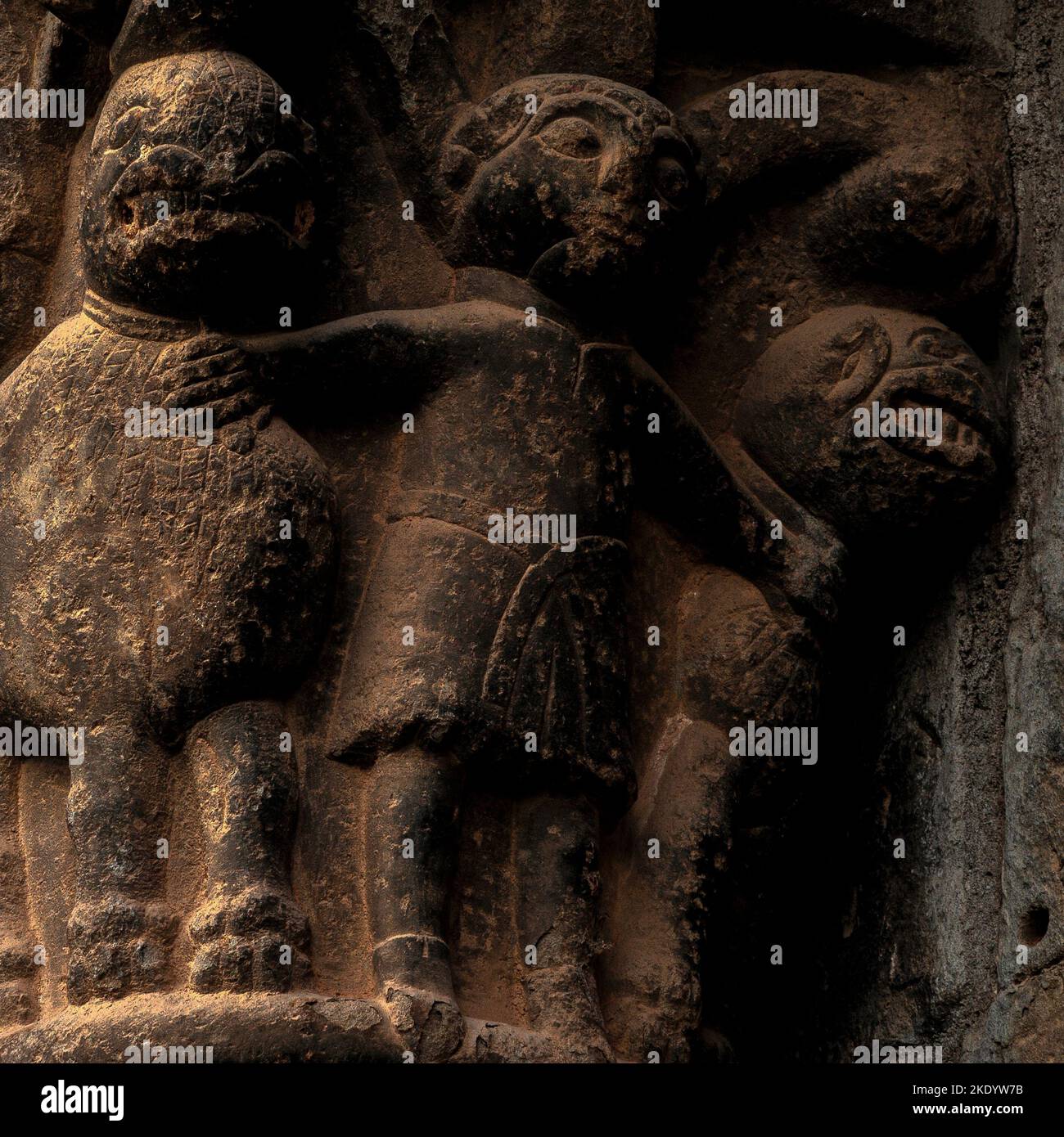 Daniel in the Lions’ Den, depicted by a medieval sculptor as a man wearing a belted tunic physically restraining two snarling lions.  Romanesque sculpted capital, west portal of former royal nunnery church of Santa Maria at Santa Cruz de la Serós in Huesca, Aragon, Spain.  The church, first mentioned in the year 1070, was built for a Benedictine nunnery, founded by the royal House of Aragon as a ‘family monastery’. Stock Photo