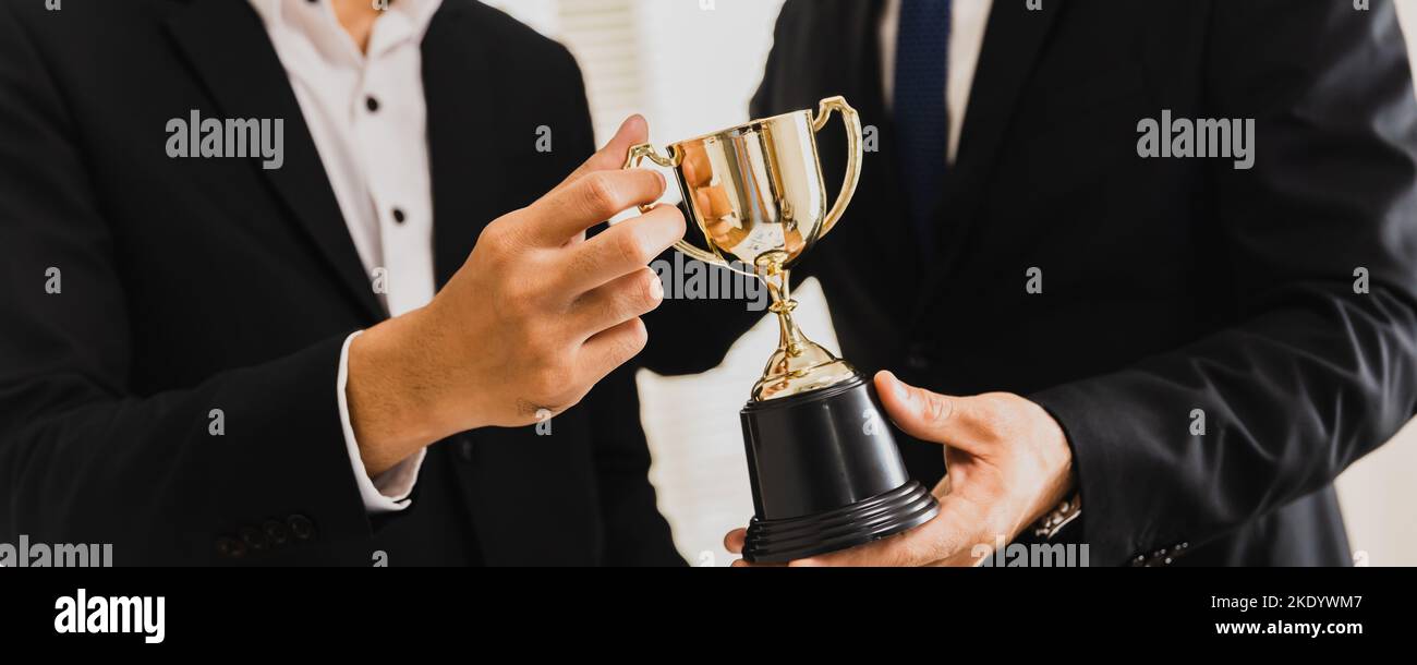 Cheerful business team winning trophy Stock Photo