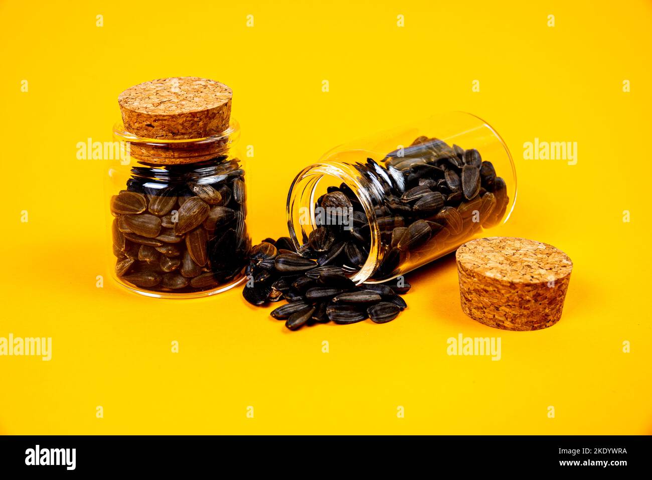 white sunflower seeds in glass jar. in bucket sunflower seeds on black background. concept white
