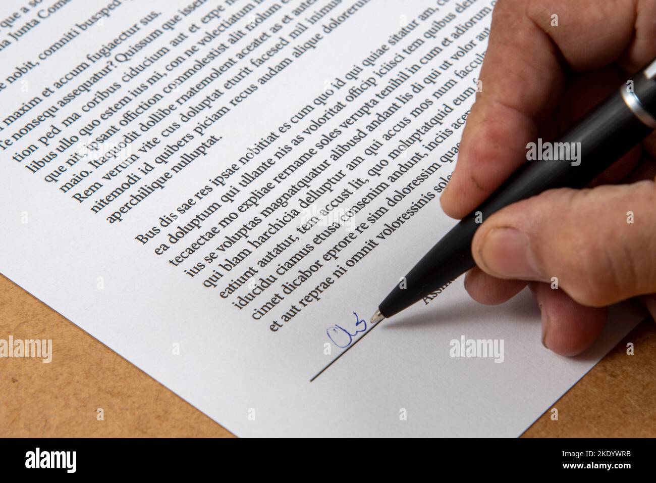 printed document signature showing a hand and ballpoint pen and hand