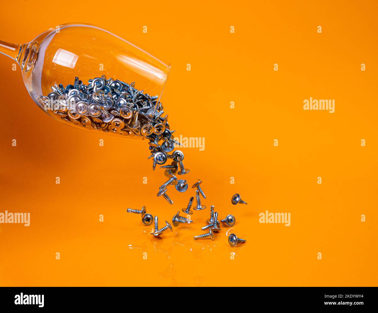 Dropped Many metal selftapping screws made of steel in a glass, in