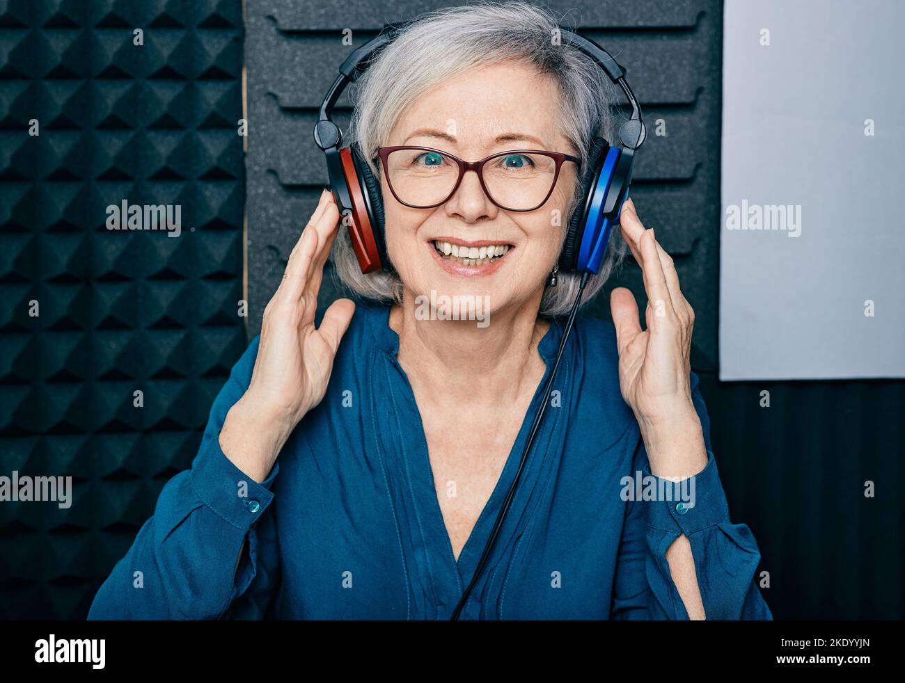 Hearing loss treatment. Positive mature woman wearing audiometry