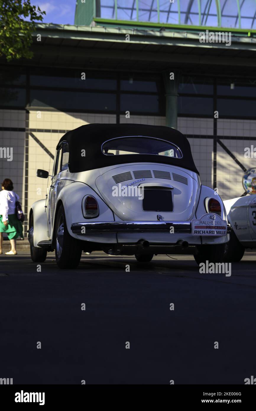 A vertical shot of a white vintage Volkswagen Beetle car on the street in Dinard, France Stock Photo