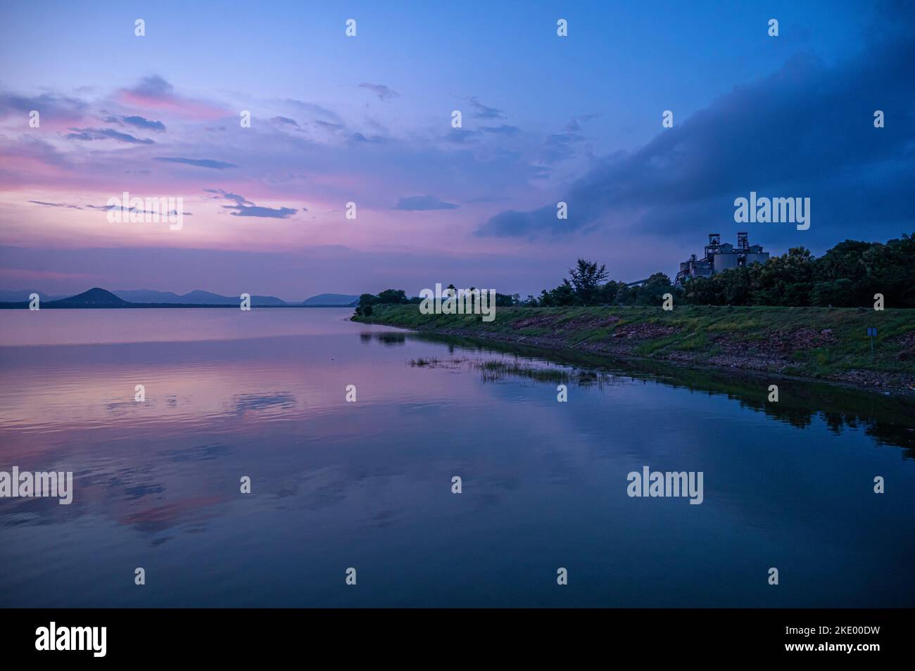 A mesmerizing view of the sunset sky reflected in a lake Stock Photo ...
