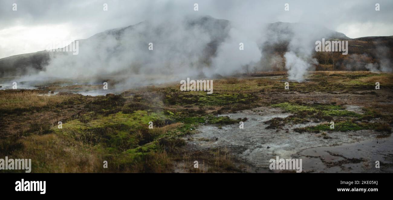 Steam coming out of the ground in geothermal area Geysir in Iceland Stock Photo