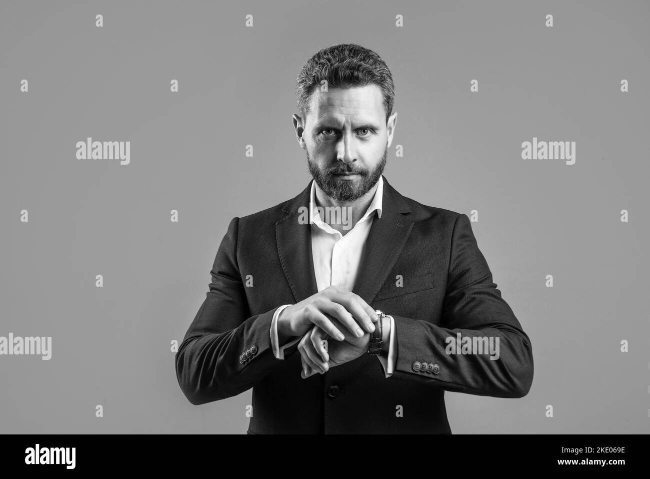 ceo man in suit with groomed beard hair show wristwatch, check time