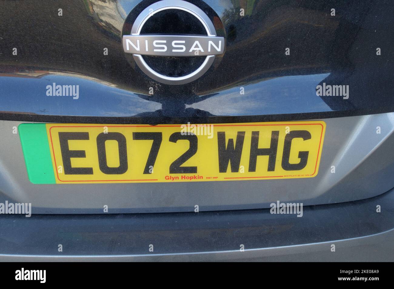 Green EV number plate indicating electric vehicle on Nissan Leaf Stock Photo